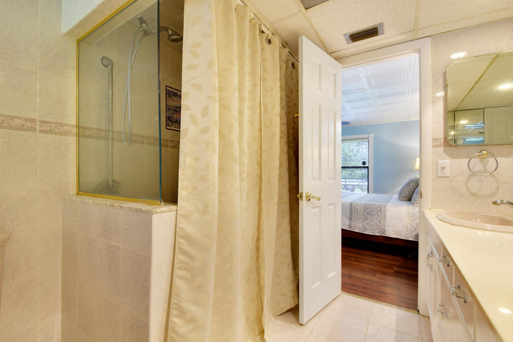 15429 Jupiter Farms Road Jupiter, FL 33478 - Photo 36 of 59 a en suite bathroom with a sink and a mirror