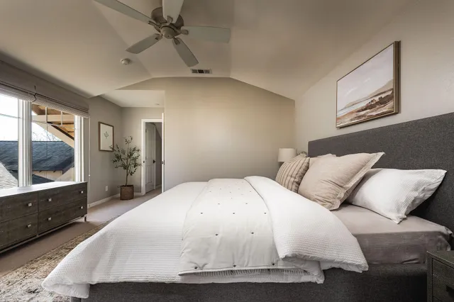 a bedroom with a large bed and a flat screen tv
