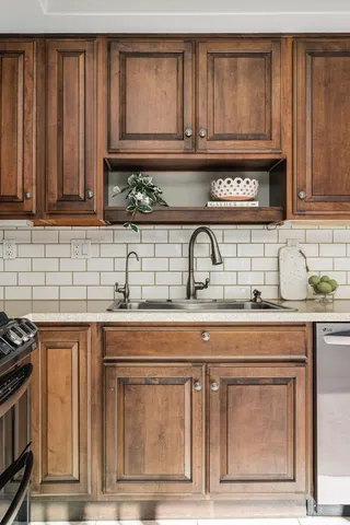 a kitchen with stainless steel appliances granite countertop a sink and cabinets