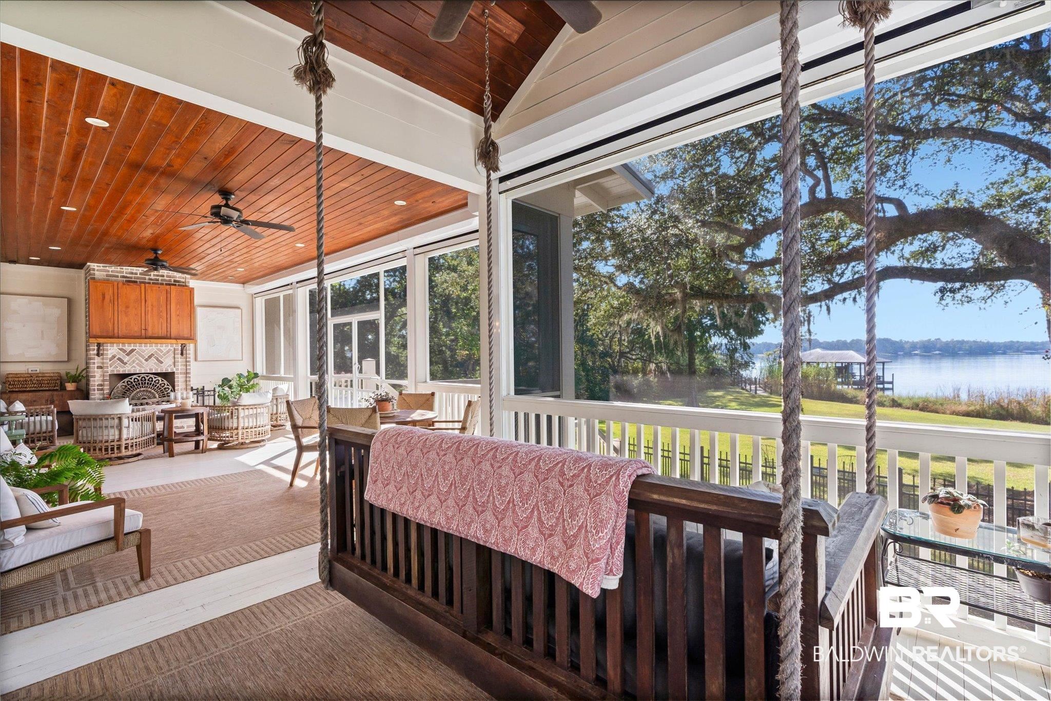 2415 Venetia Road Mobile, AL 36605 - Photo 31 of 50 Sunroom with an outdoor living space with a fireplace, a ceiling fan, and a water view