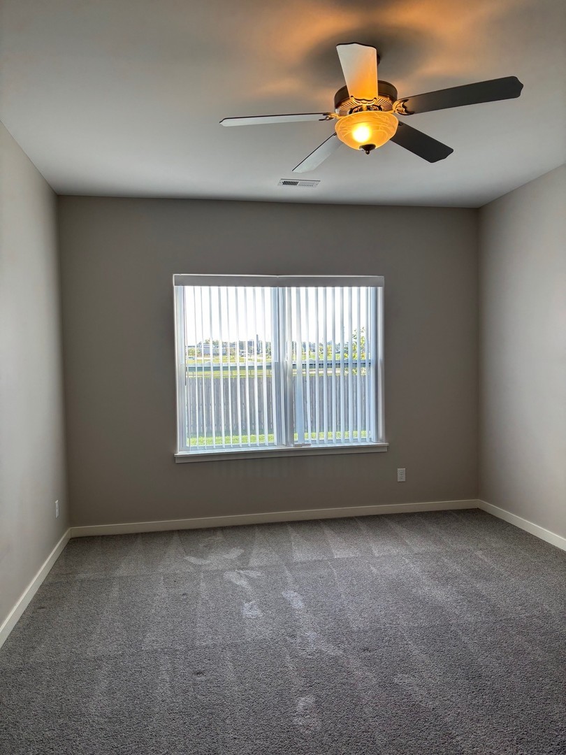 610 Anjali Court, Unit R Sycamore, IL 60178 - Photo 13 of 20 a view of an empty room with a window