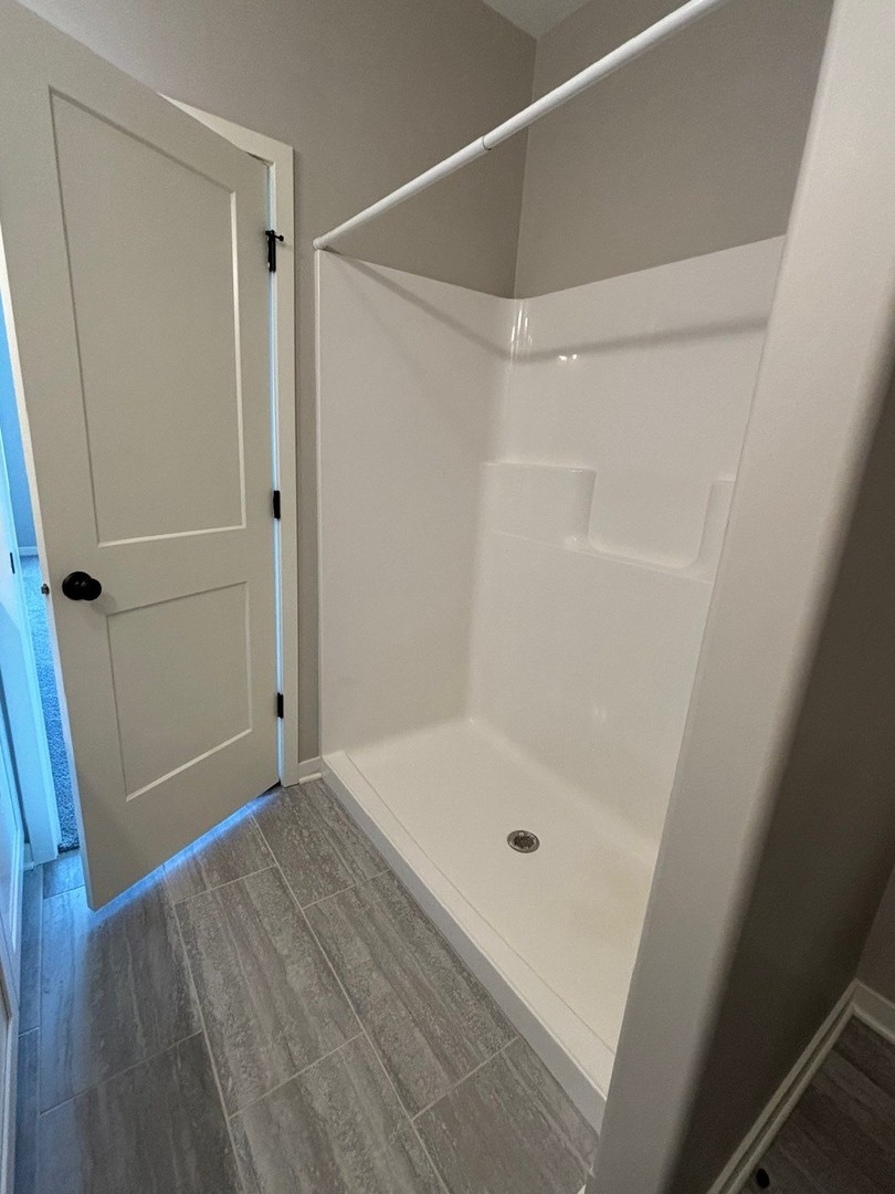 610 Anjali Court, Unit R Sycamore, IL 60178 - Photo 17 of 20 a bathroom with a glass shower door