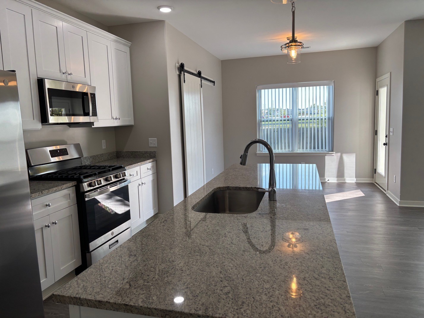 610 Anjali Court, Unit R Sycamore, IL 60178 - Photo 5 of 20 a kitchen with a stove a sink and a microwave