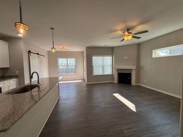 a living room with fireplace furniture and a wooden floor