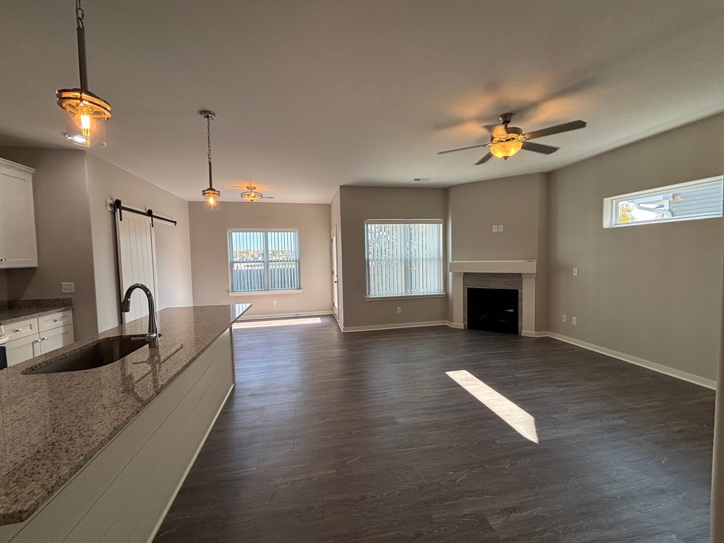 610 Anjali Court, Unit R Sycamore, IL 60178 - Photo 6 of 20 a living room with fireplace furniture and a wooden floor
