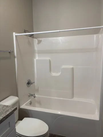 a bathroom with a toilet and a bathtub