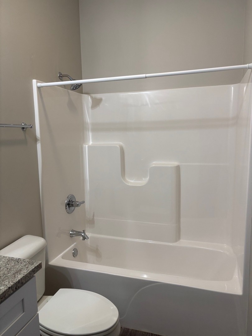610 Anjali Court, Unit R Sycamore, IL 60178 - Photo 10 of 20 a bathroom with a toilet and a bathtub