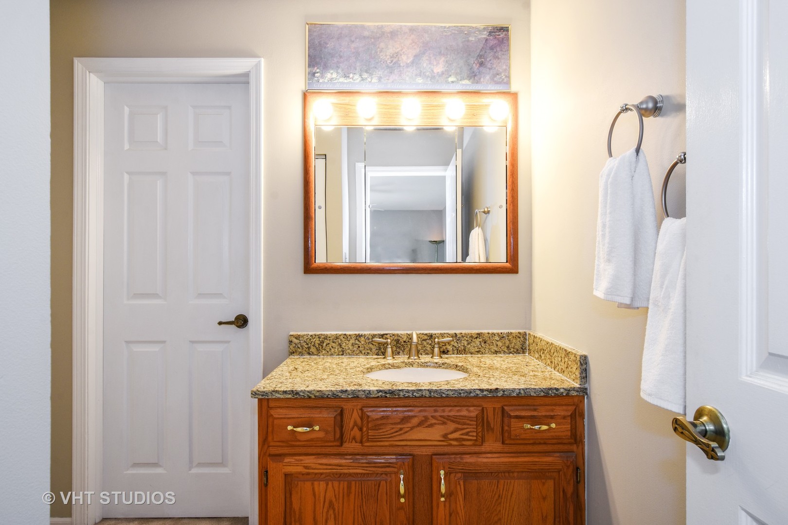 1320 Devonshire Road Buffalo Grove, IL 60089 - Photo 14 of 25 a view of bathroom with a granite countertop sink and a mirror