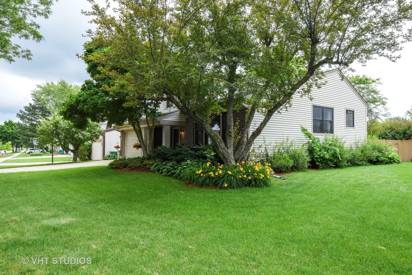 1320 Devonshire Road Buffalo Grove, IL 60089 - Photo 22 of 25 a front view of a house with a garden