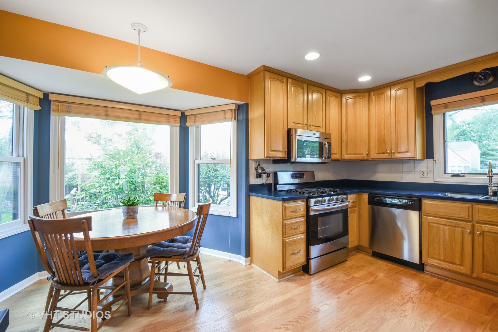 1320 Devonshire Road Buffalo Grove, IL 60089 - Photo 6 of 25 a kitchen with stainless steel appliances granite countertop wooden floor a stove a sink and a granite counter top