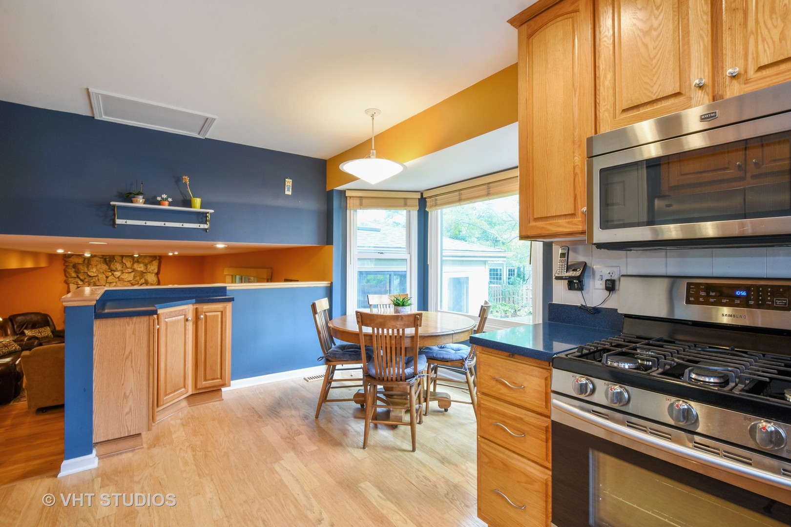 1320 Devonshire Road Buffalo Grove, IL 60089 - Photo 7 of 25 a kitchen with stainless steel appliances granite countertop a stove a sink and a microwave
