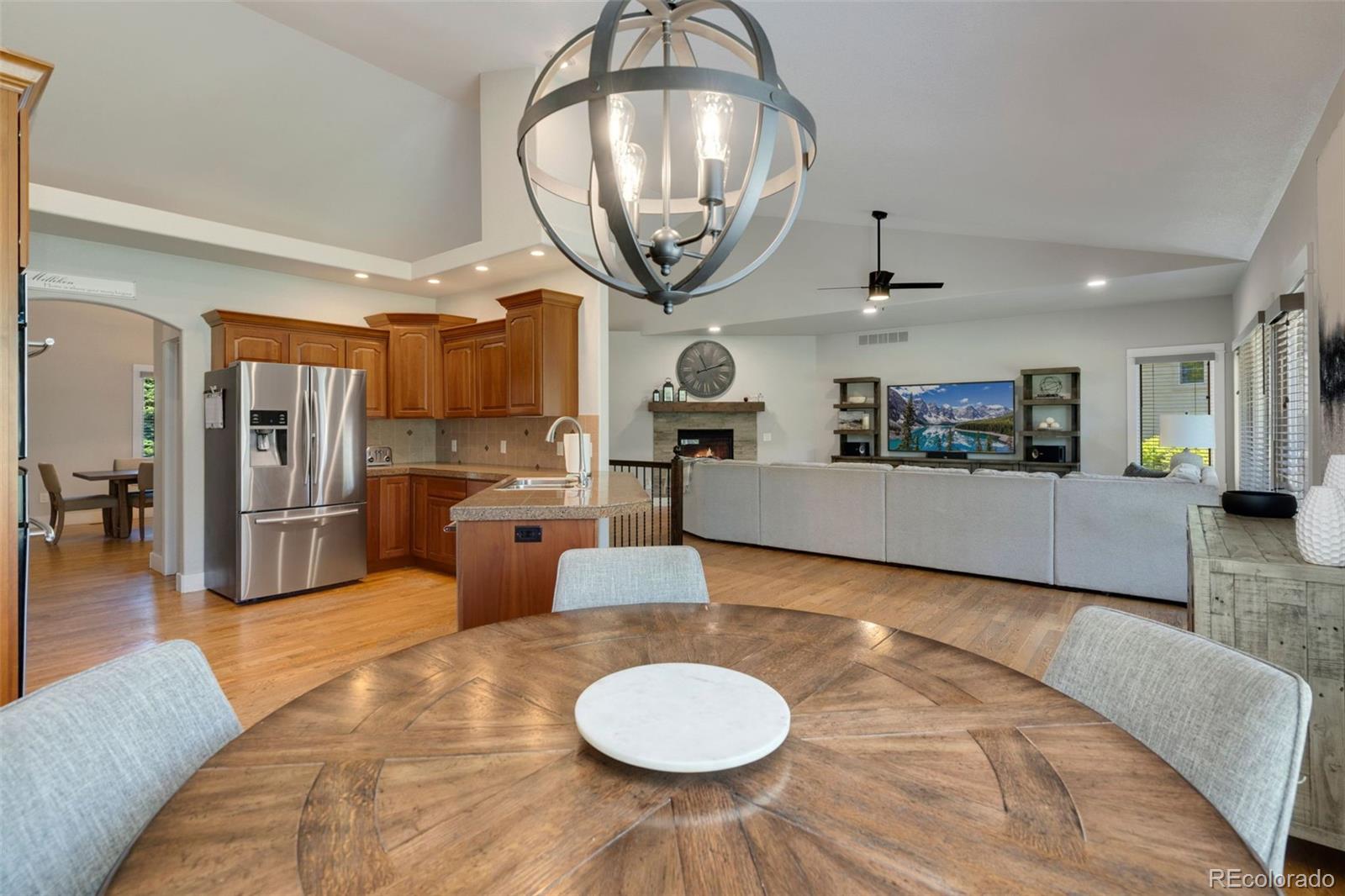 5475 Trade Wind Drive Windsor, CO 80528 - Photo 11 of 40 a living room with furniture a mirror and a view of kitchen