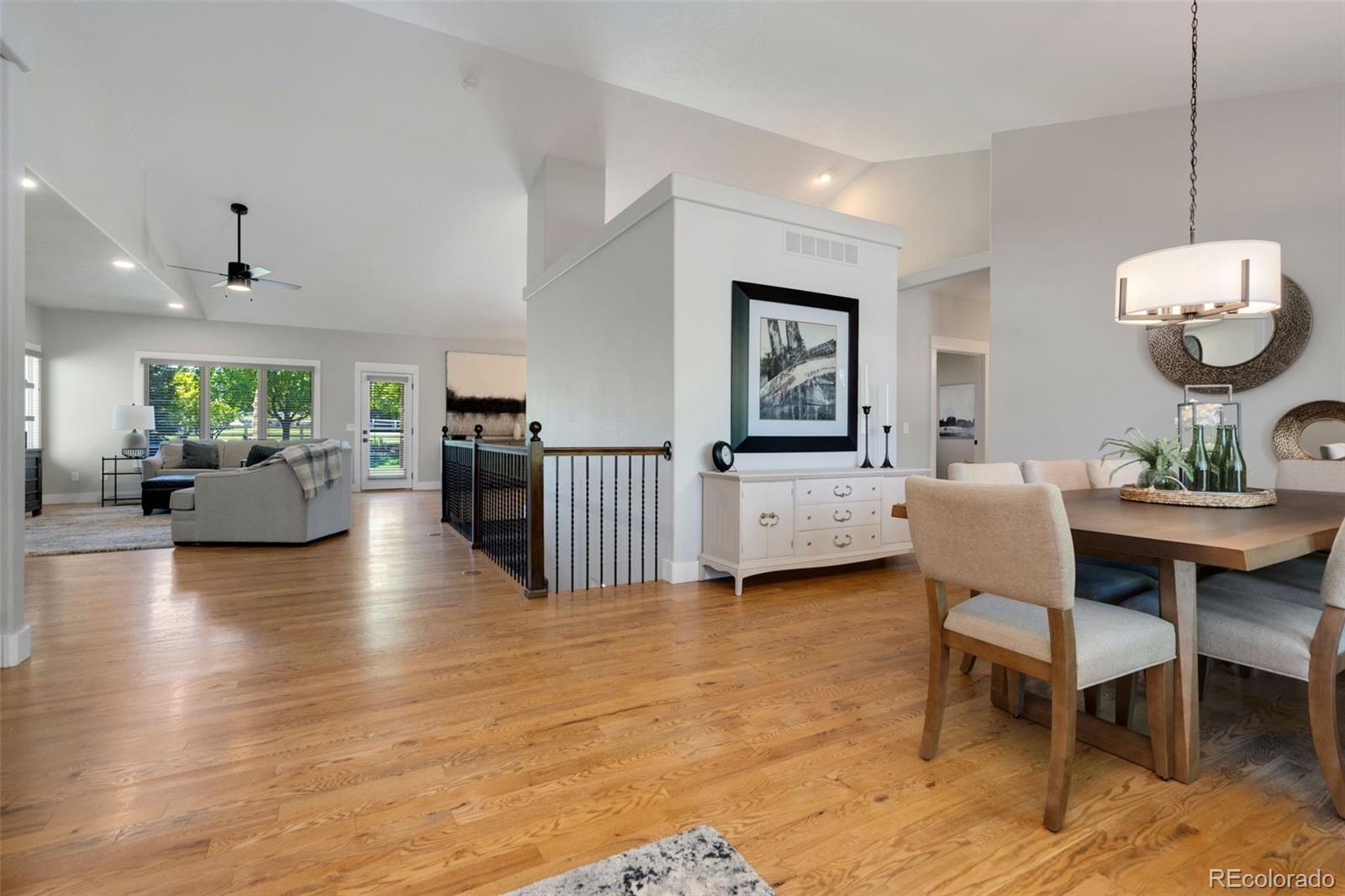 5475 Trade Wind Drive Windsor, CO 80528 - Photo 12 of 40 a view of a dining room with furniture and wooden floor