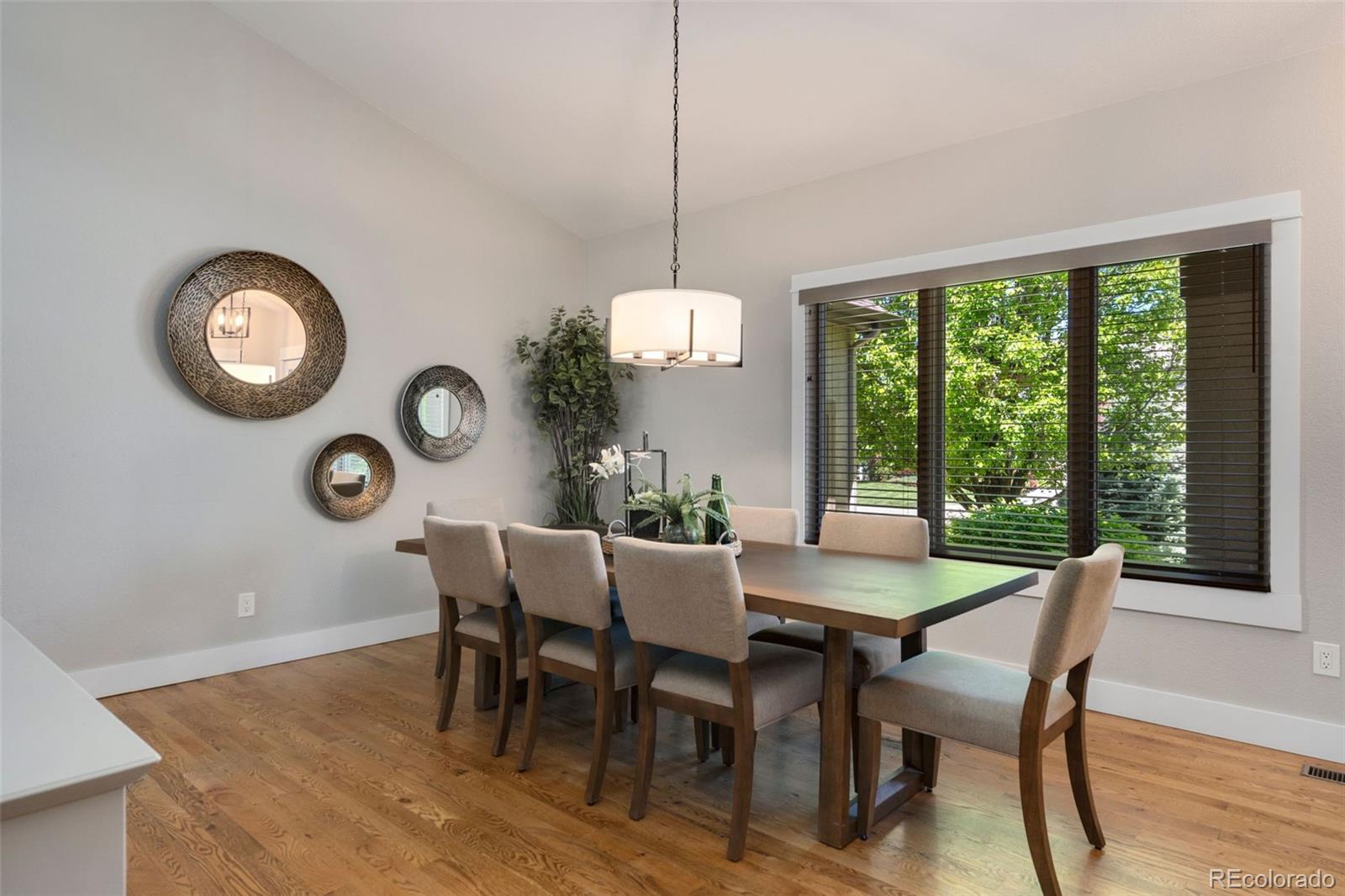 5475 Trade Wind Drive Windsor, CO 80528 - Photo 13 of 40 a view of a dining room with furniture window and wooden floor