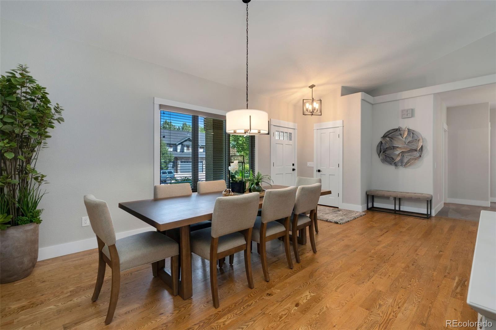 5475 Trade Wind Drive Windsor, CO 80528 - Photo 14 of 40 a view of a dining room with furniture window and wooden floor