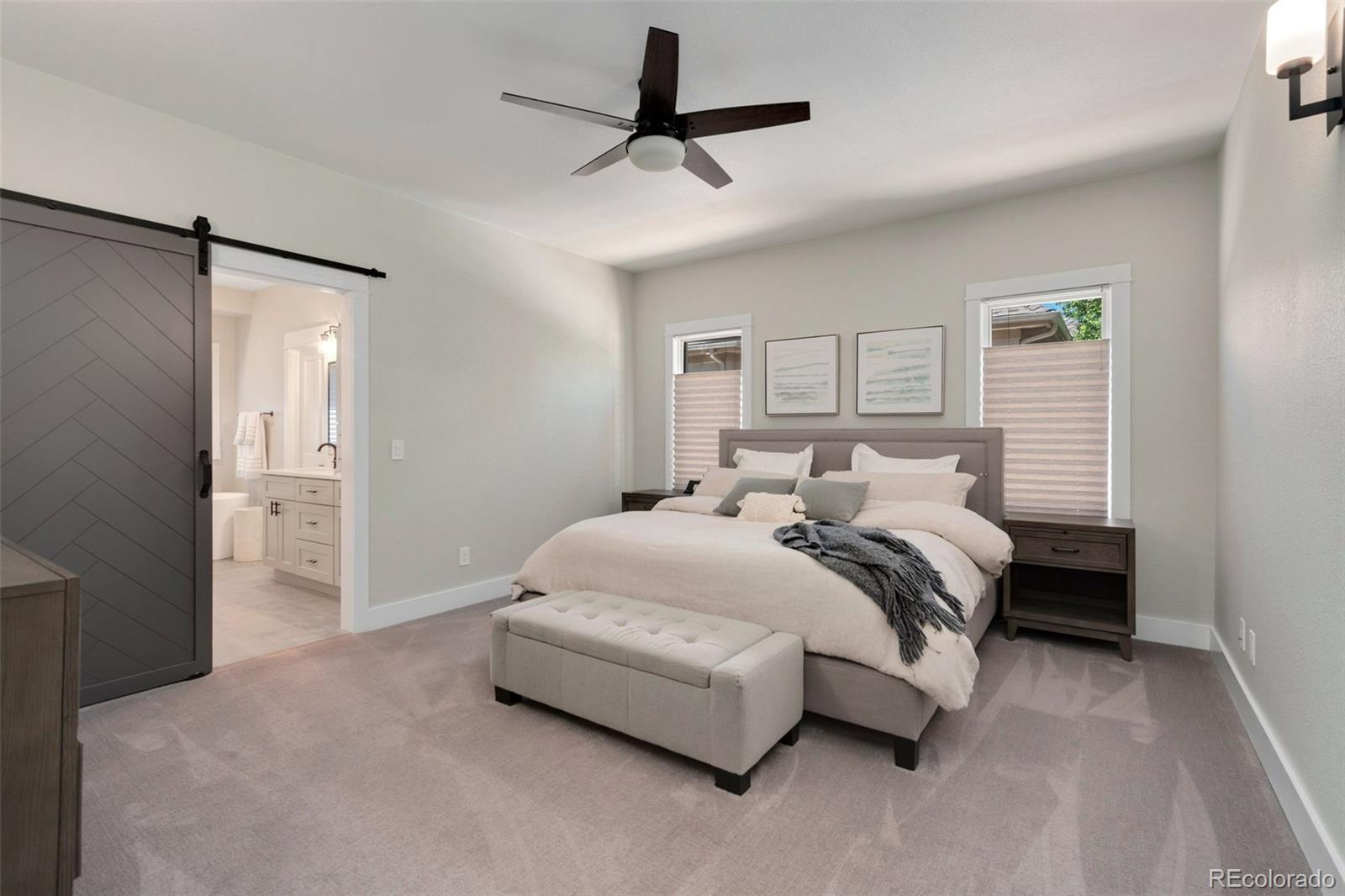 5475 Trade Wind Drive Windsor, CO 80528 - Photo 17 of 40 a spacious bedroom with a bed and a chandelier