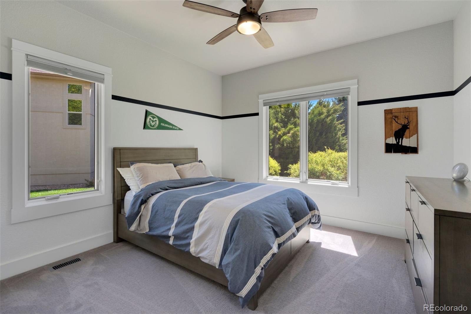 5475 Trade Wind Drive Windsor, CO 80528 - Photo 24 of 40 a bed sitting in a bedroom next to a window