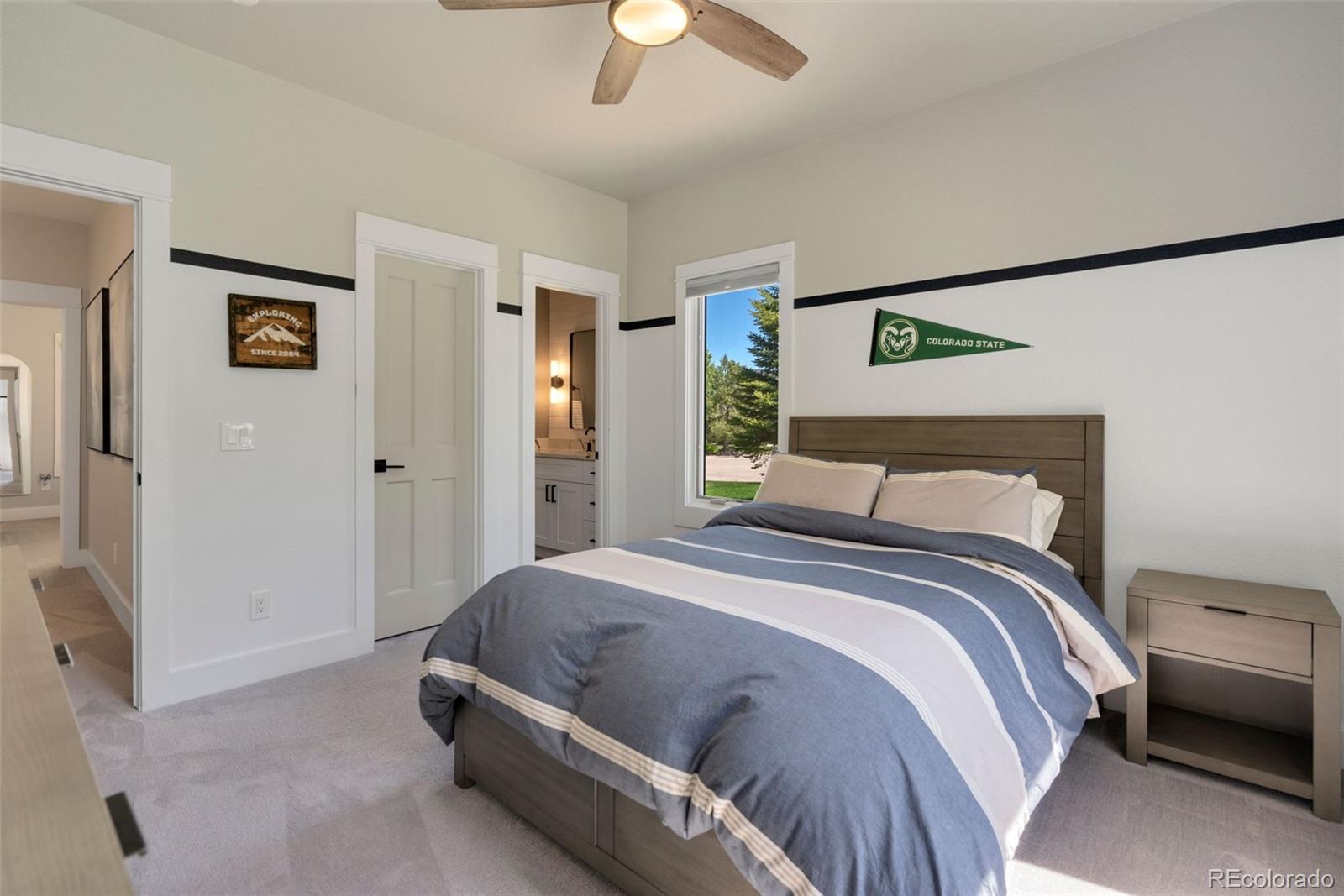 5475 Trade Wind Drive Windsor, CO 80528 - Photo 25 of 40 a bedroom with a bed and a chandelier