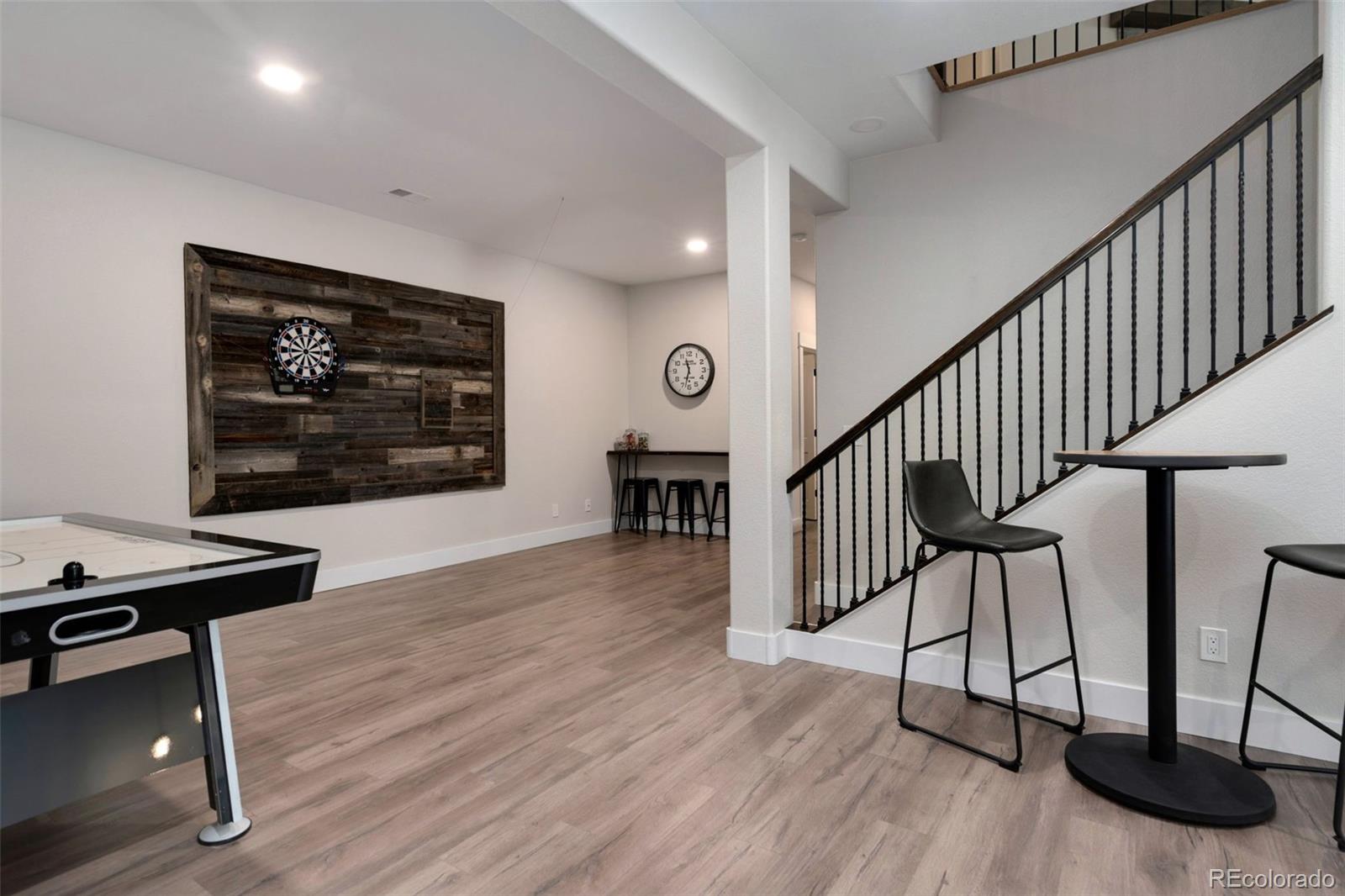 5475 Trade Wind Drive Windsor, CO 80528 - Photo 27 of 40 a view of a hallway with wooden floor and staircase