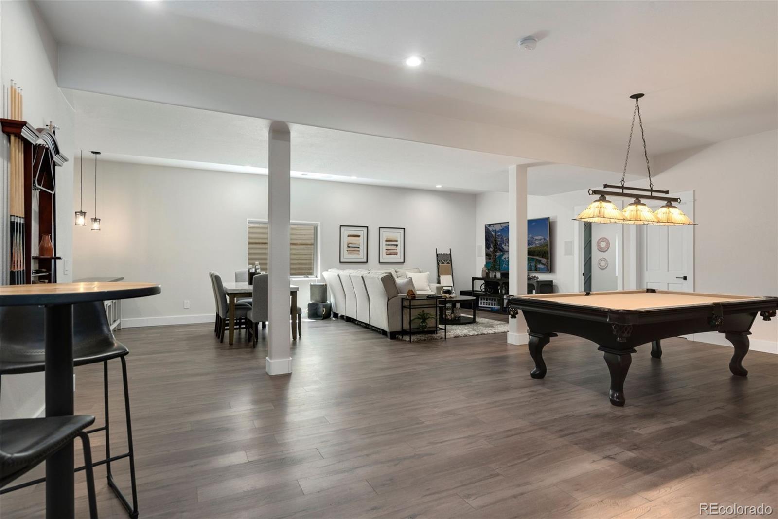 5475 Trade Wind Drive Windsor, CO 80528 - Photo 28 of 40 a living room with furniture a window and a chandelier