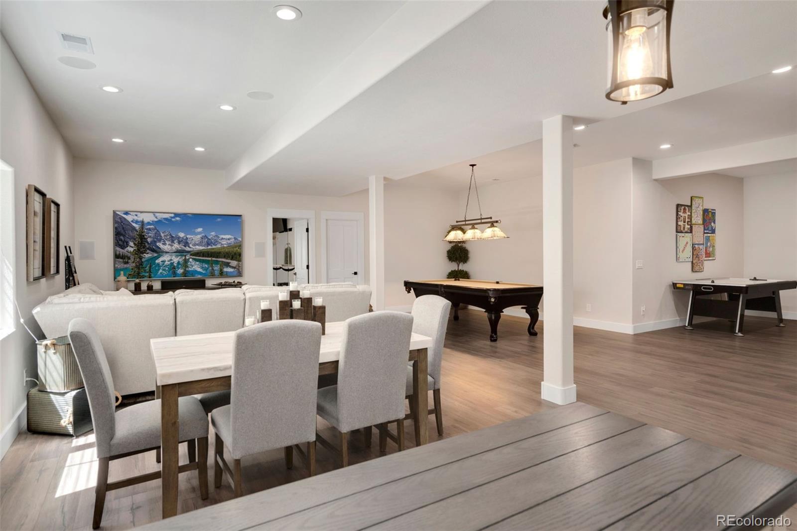 5475 Trade Wind Drive Windsor, CO 80528 - Photo 31 of 40 a view of a dining room with furniture and wooden floor