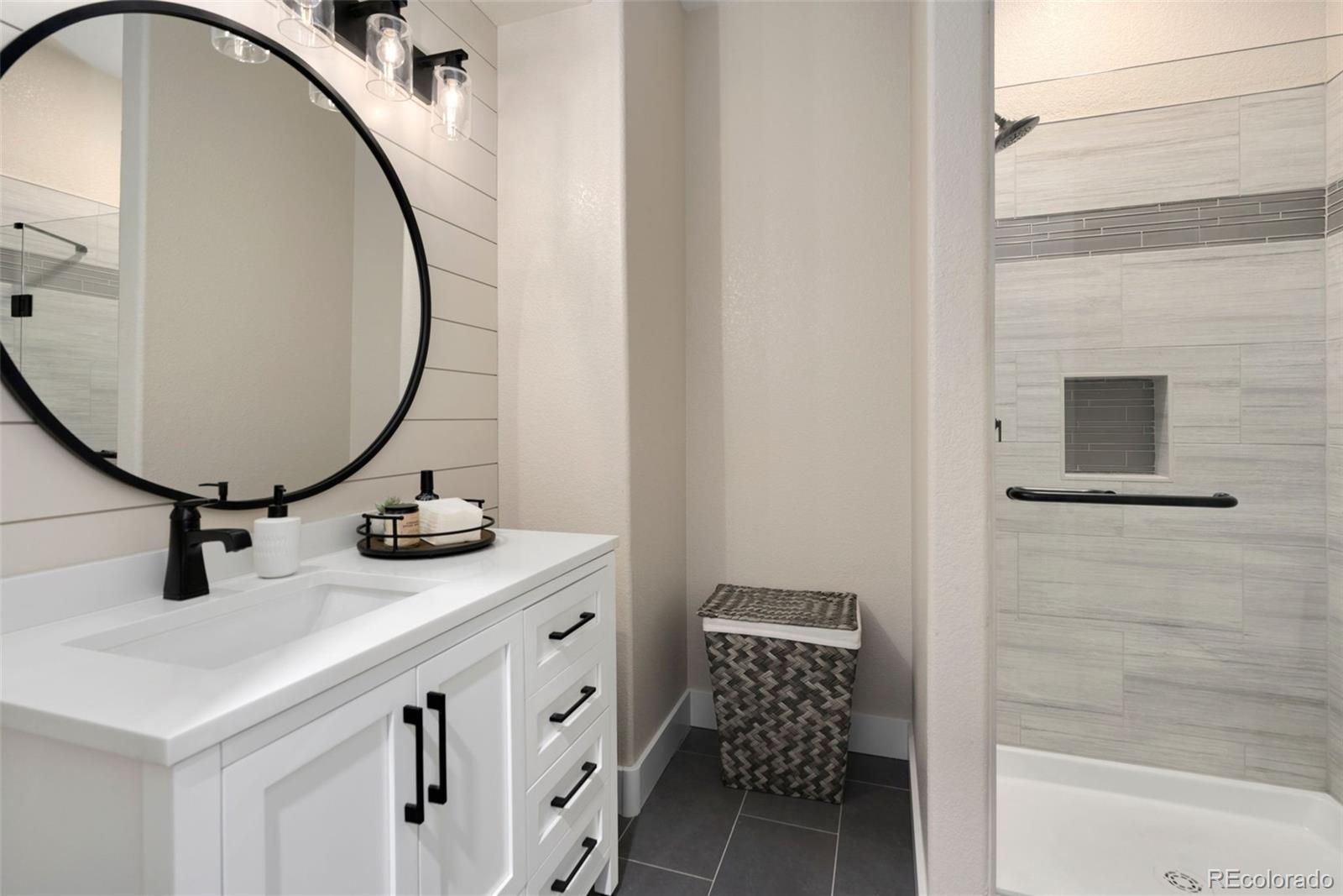 5475 Trade Wind Drive Windsor, CO 80528 - Photo 34 of 40 a bathroom with a sink and a mirror