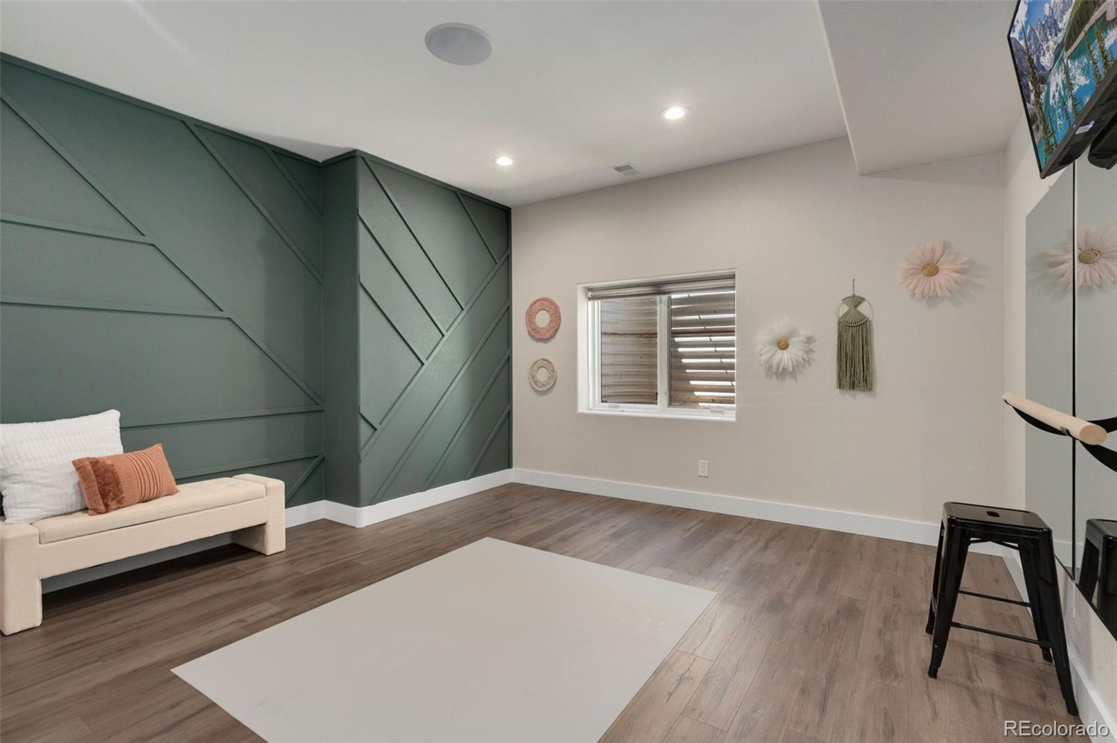 5475 Trade Wind Drive Windsor, CO 80528 - Photo 35 of 40 a living room with furniture and wooden floor