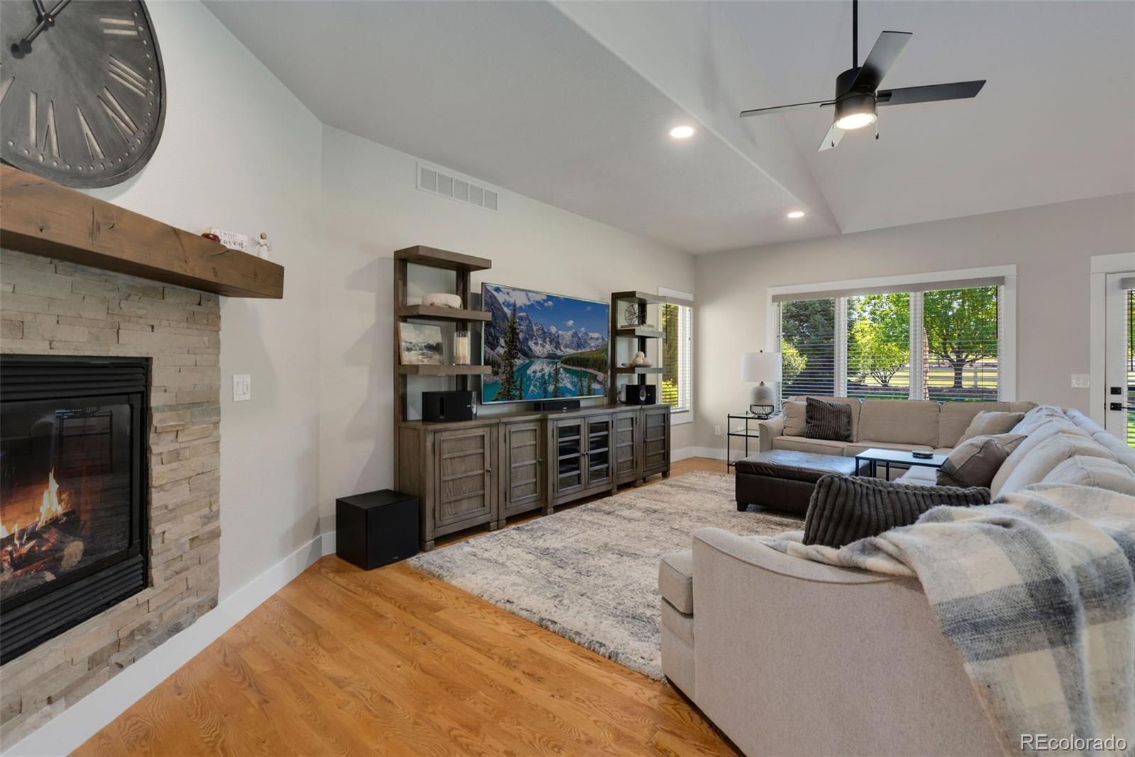 5475 Trade Wind Drive Windsor, CO 80528 - Photo 4 of 40 a living room with furniture a window and a fireplace