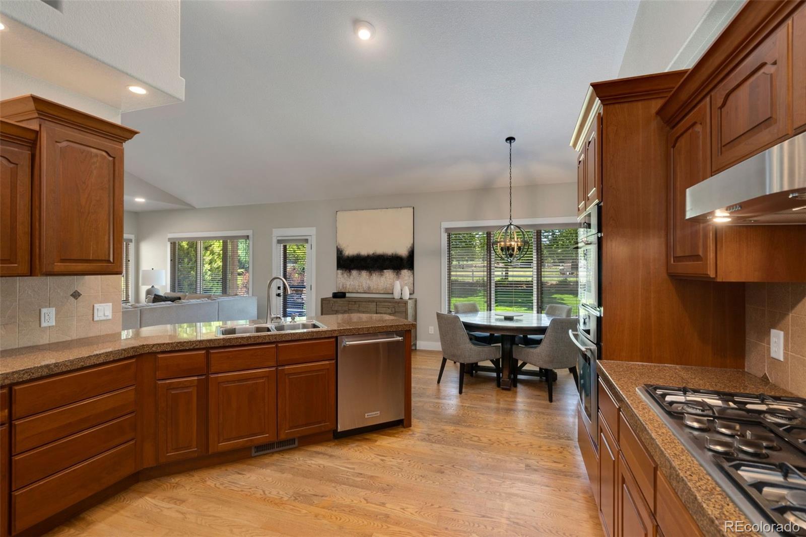 5475 Trade Wind Drive Windsor, CO 80528 - Photo 9 of 40 a kitchen with a sink and wooden cabinets
