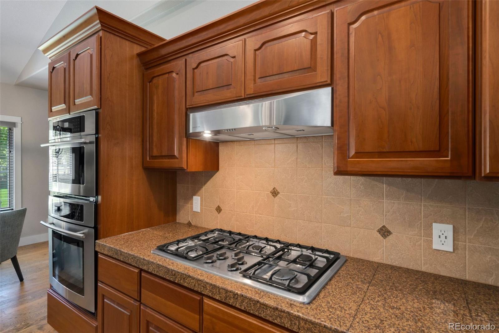 5475 Trade Wind Drive Windsor, CO 80528 - Photo 10 of 40 a kitchen with stainless steel appliances granite countertop a stove and a refrigerator