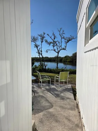 a view of a backyard with a table and chairs with wooden fence