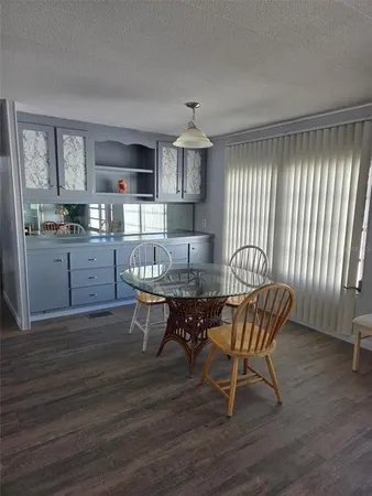 a living room with granite countertop furniture a fireplace and kitchen view