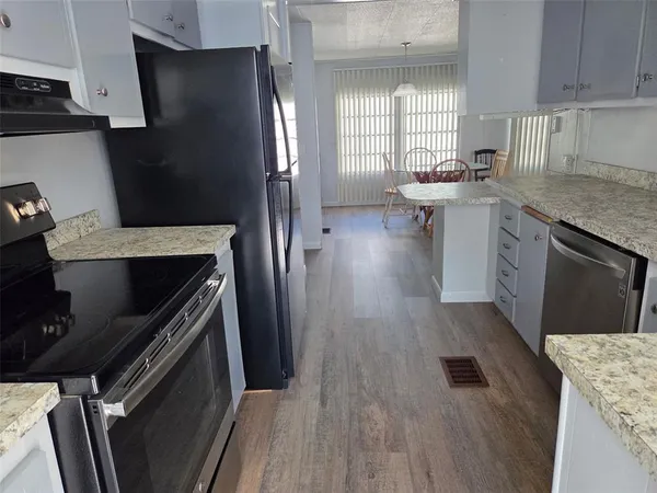 a kitchen with a sink stove and refrigerator