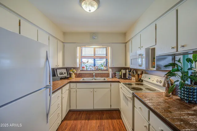 a kitchen with a sink stove and cabinets