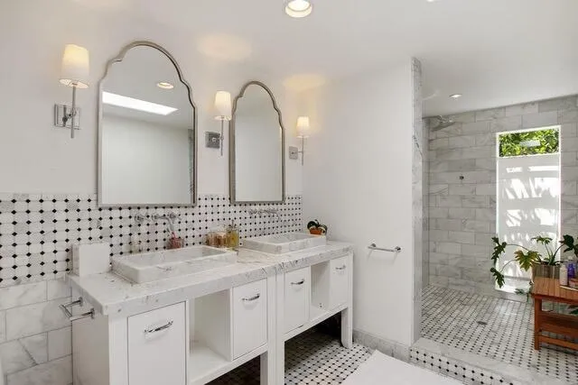 a bathroom with a double vanity sink and a mirror