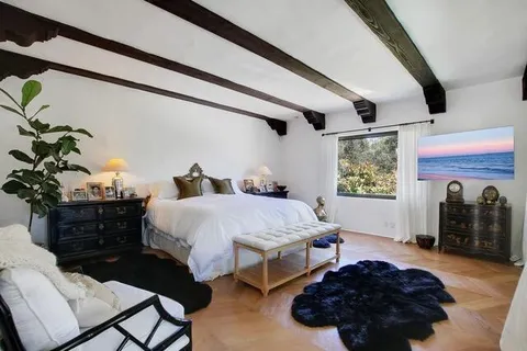 a bed room with a bed and a potted plant