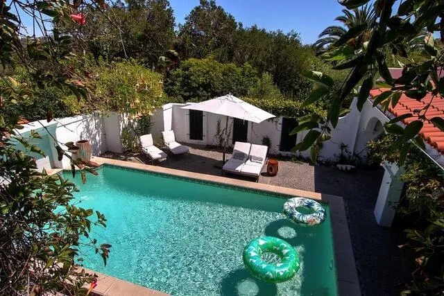 a view of a garden with an outdoor seating