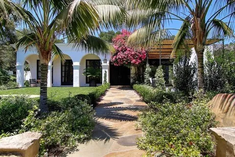a front view of house with yard and green space