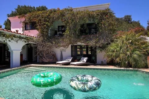 a view of a house with a backyard