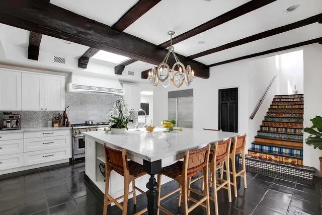 a kitchen with a dining table and chairs