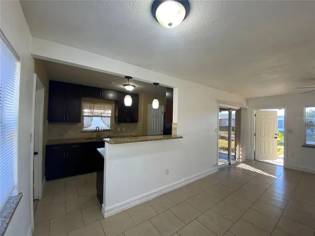 a open kitchen with a sink and dishwasher a stove top oven with wooden floor