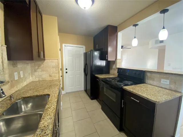 a kitchen with a stove and a sink