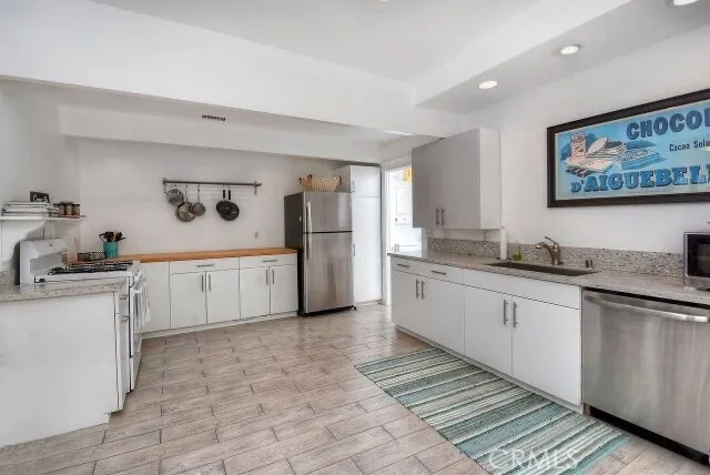a kitchen with white cabinets and white appliances