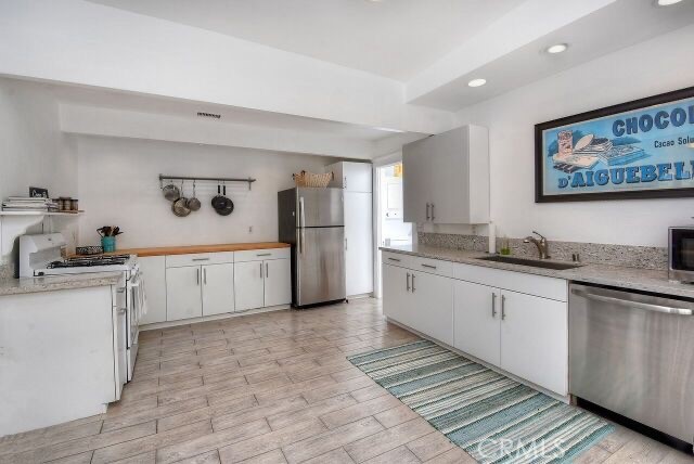 372 Jasmine Street Laguna Beach, CA 92651 - Photo 11 of 20 a large white kitchen with a stove a sink dishwasher and a refrigerator