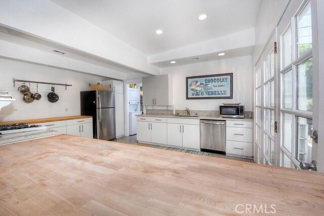 372 Jasmine Street Laguna Beach, CA 92651 - Photo 13 of 20 a large white kitchen with granite countertop a refrigerator and a stove top oven