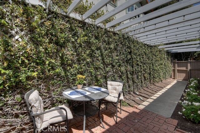 372 Jasmine Street Laguna Beach, CA 92651 - Photo 16 of 20 a balcony with a table and chairs and potted plants