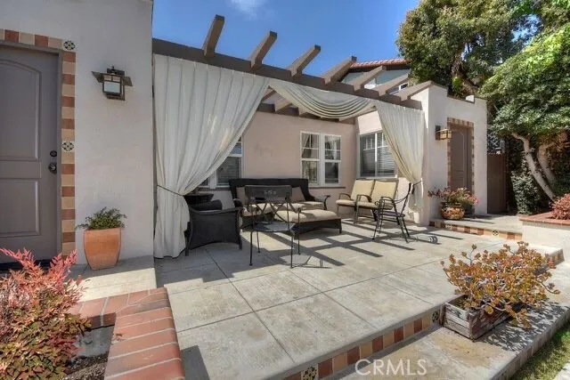 a view of a patio with table and chairs and potted plants