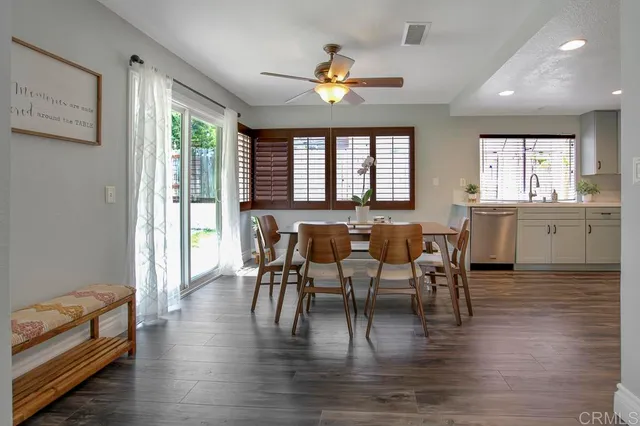 a view of a a dining room with furniture window and wooden floor