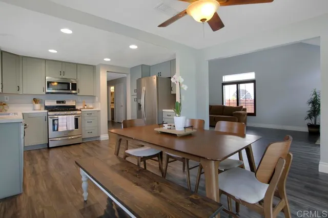 a view of kitchen with cabinets table and chairs