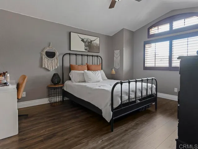 a bedroom with a bed window and a table